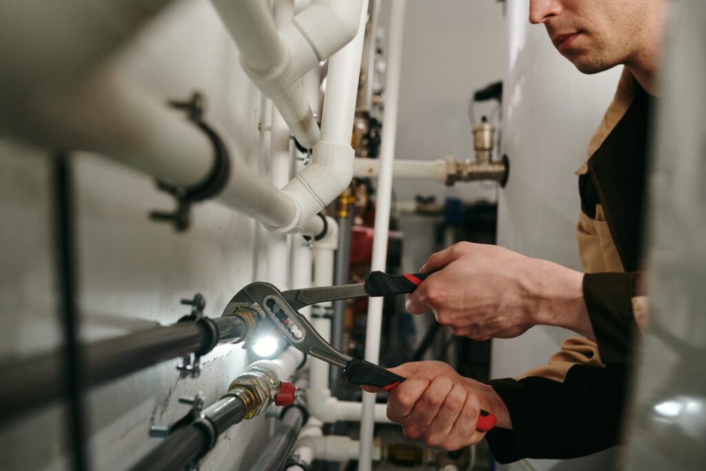 Plumbers maintaining commercial plumbing pipes in Powder Springs