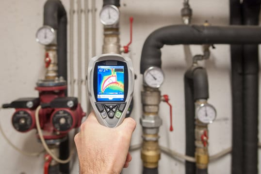 Plumber using a thermal imaging camera to inspect pipes in Powder Springs