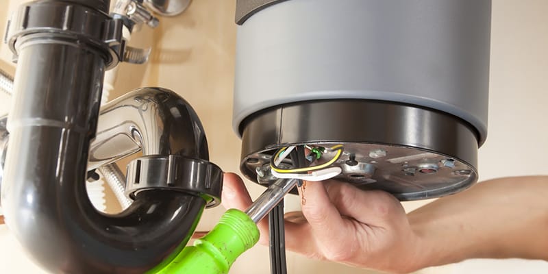 Technician repairing the heating element of a water heater in Powder Springs