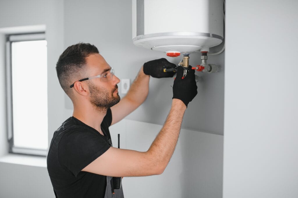Technician performing water heater maintenance in Powder Springs