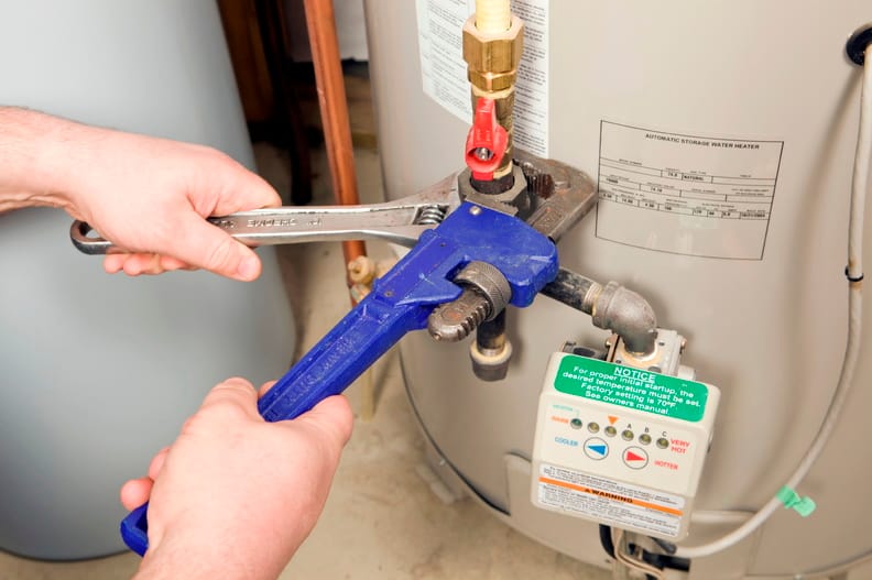 Plumber repairing a water heater valve in Powder Springs